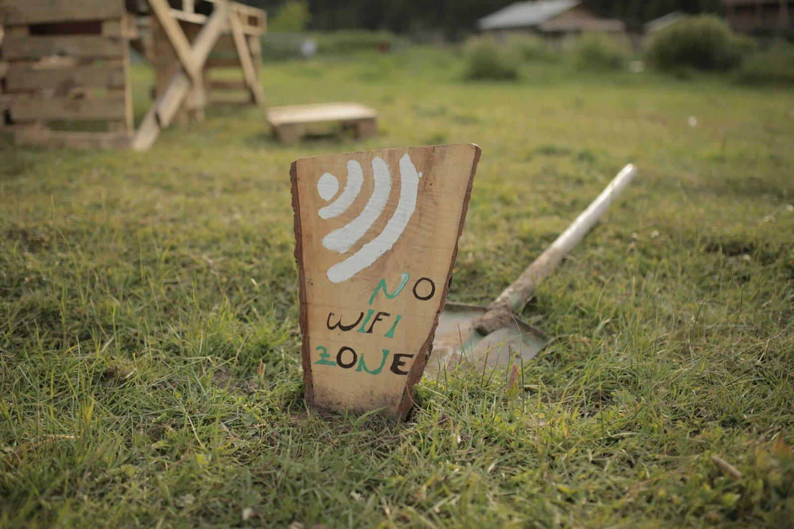 brown wooden i love you print board on green grass during daytime